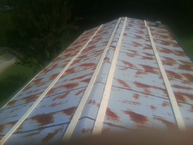 Rusted metal roof panels with new wood purlins before replacement — Storm Damage Roof Repair in Dickerson Run by Roofing Brothers