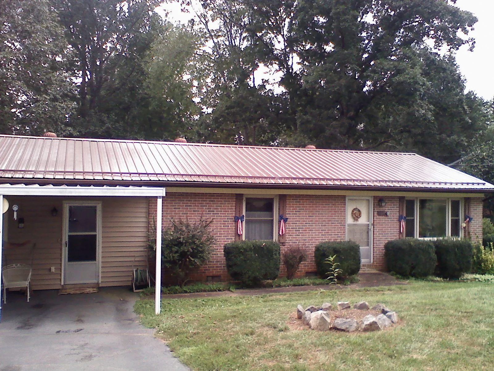 Bronze metal roof and carport on a brick ranch home — Roof Repair work by our crew in Dickerson Run