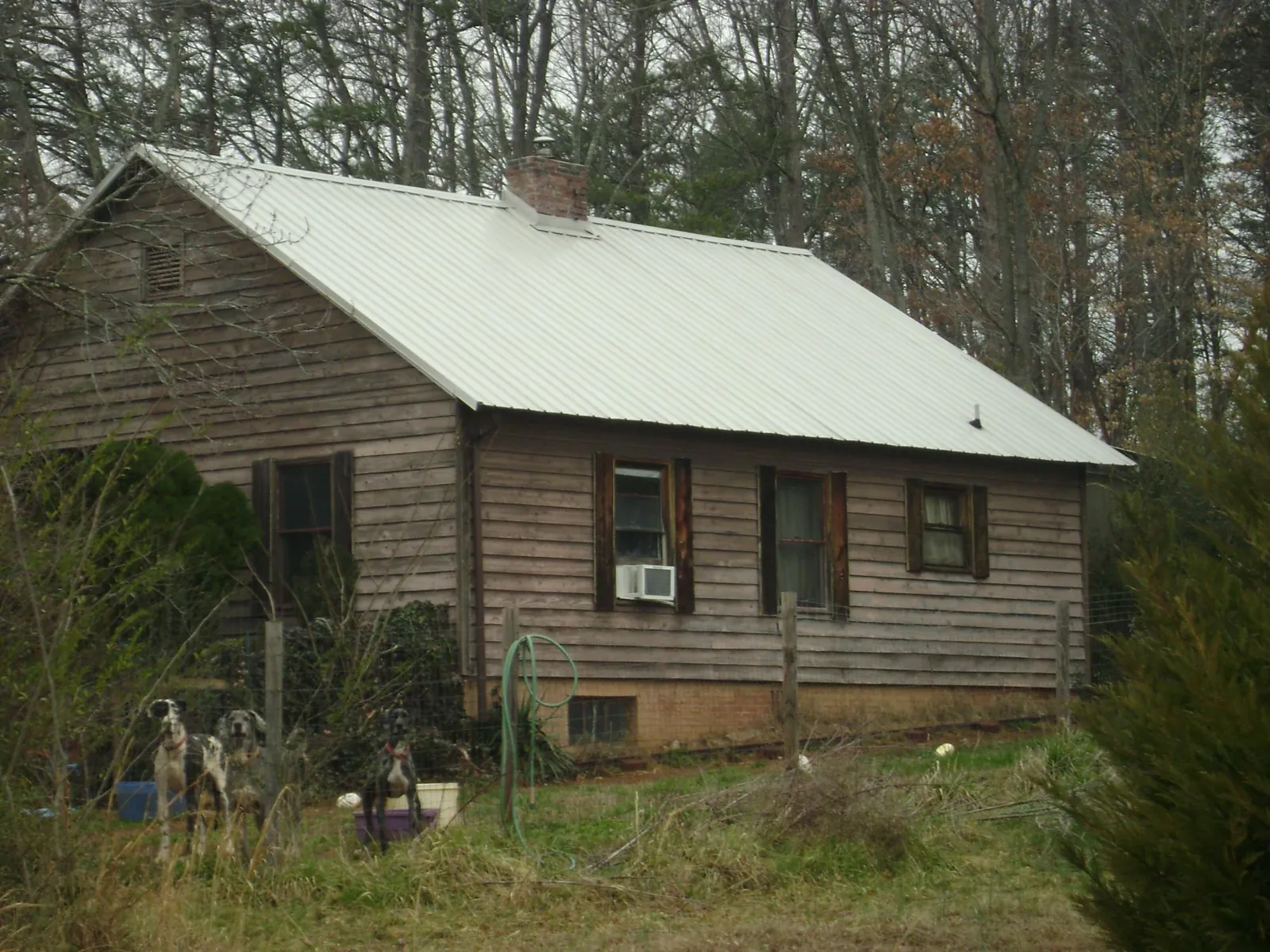 White metal roof on an old wood sided farmhouse, from a Metal Roof Installation job in Dickerson Run